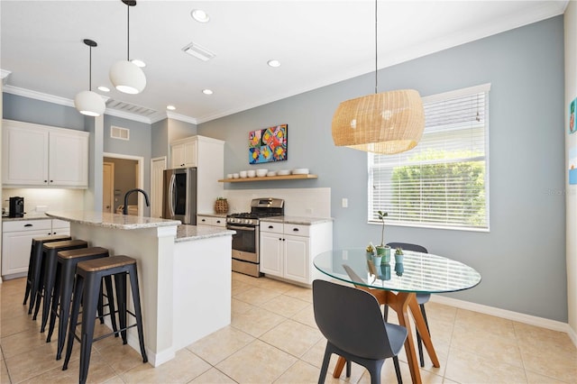 kitchen featuring tasteful backsplash, pendant lighting, a center island with sink, stainless steel appliances, and white cabinets