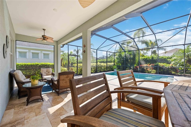 view of patio / terrace with ceiling fan, an outdoor living space, and glass enclosure