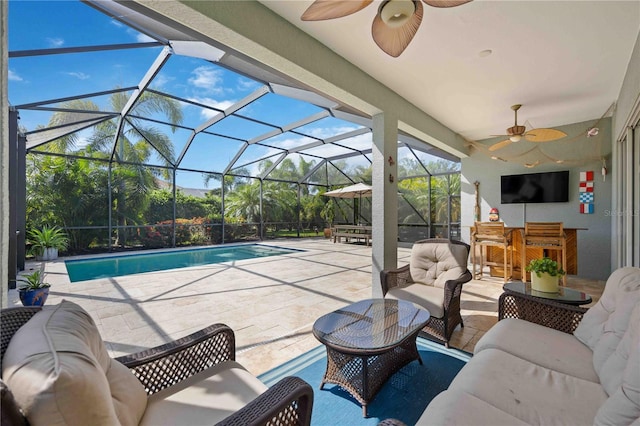 view of patio featuring an outdoor hangout area, ceiling fan, glass enclosure, and a bar