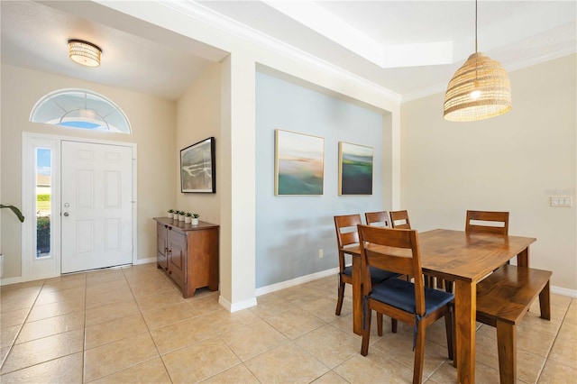 dining space featuring light tile patterned flooring and crown molding