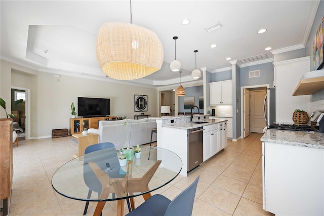 kitchen featuring white cabinetry, pendant lighting, and a raised ceiling