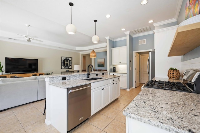 kitchen with pendant lighting, appliances with stainless steel finishes, white cabinetry, sink, and ceiling fan