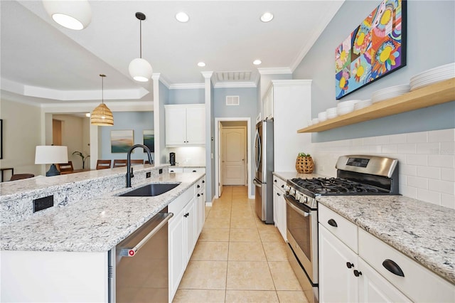 kitchen with appliances with stainless steel finishes, white cabinetry, and sink