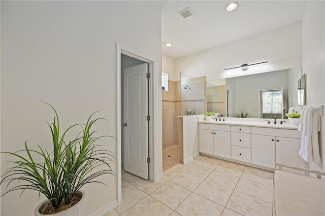 bathroom with vanity, tile patterned floors, and tiled shower