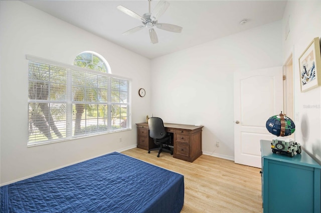 bedroom with ceiling fan, lofted ceiling, light hardwood / wood-style flooring, and multiple windows