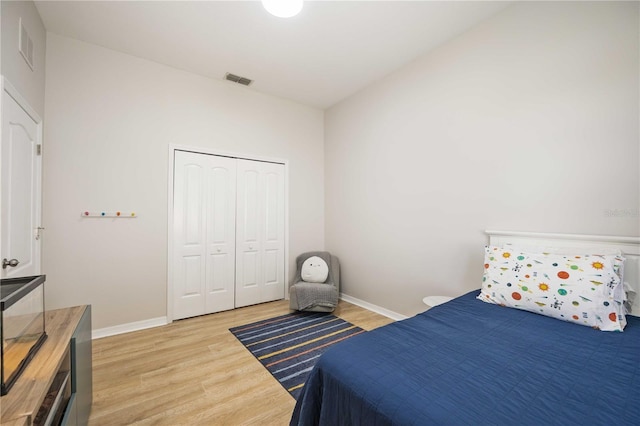 bedroom with a closet and light hardwood / wood-style flooring