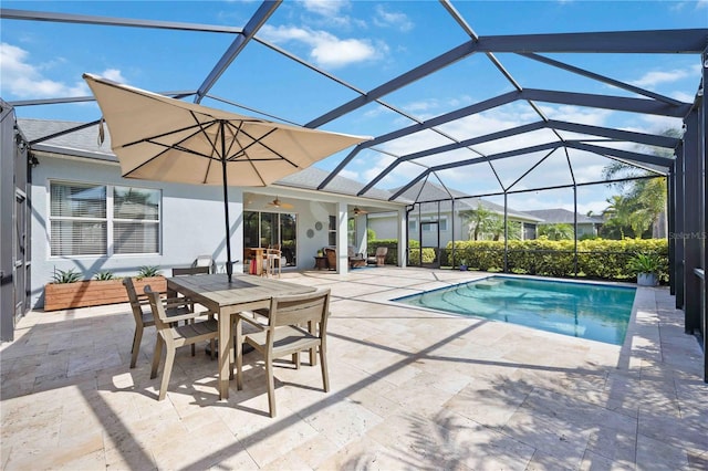 view of swimming pool featuring ceiling fan, a patio area, and glass enclosure