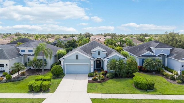 view of front of property with a front lawn and a garage