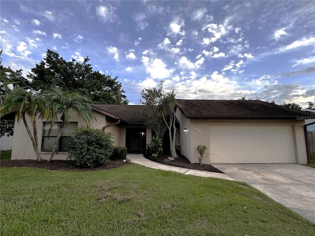 ranch-style house featuring a garage and a front yard