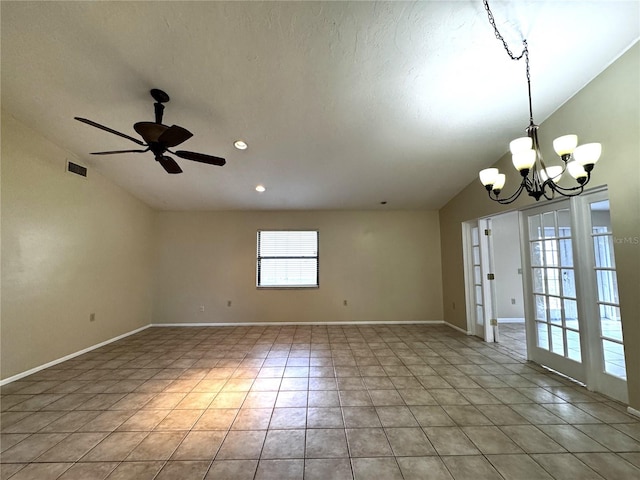 empty room with light tile patterned flooring, ceiling fan with notable chandelier, and vaulted ceiling