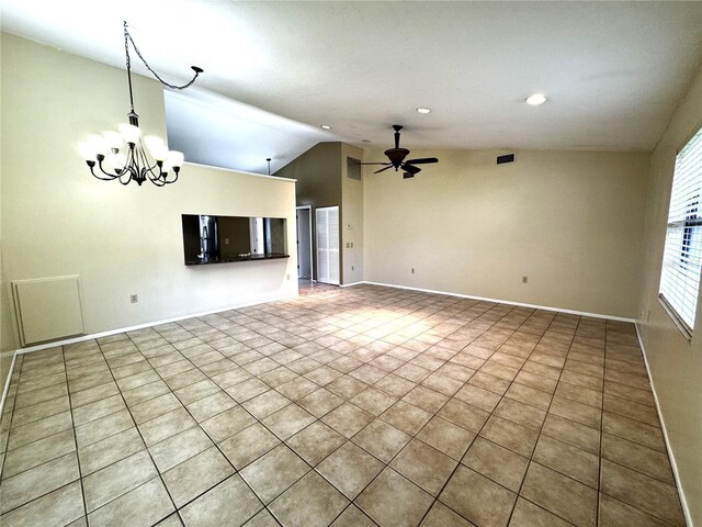 unfurnished living room featuring vaulted ceiling, light tile patterned floors, and ceiling fan with notable chandelier