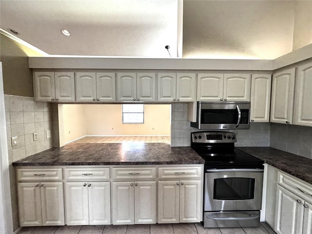 kitchen with white cabinets, stainless steel appliances, and light tile patterned floors