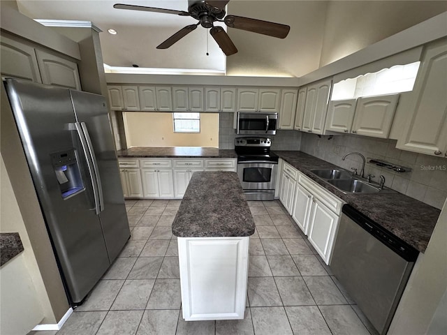 kitchen featuring decorative backsplash, stainless steel appliances, sink, and a kitchen island