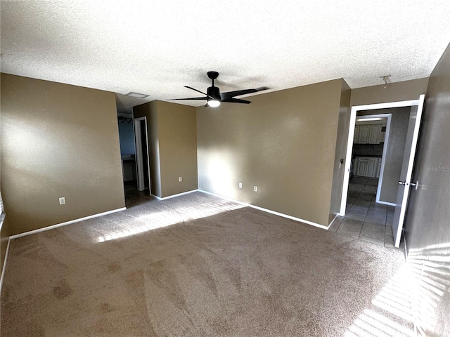 unfurnished bedroom featuring ceiling fan, a textured ceiling, and carpet