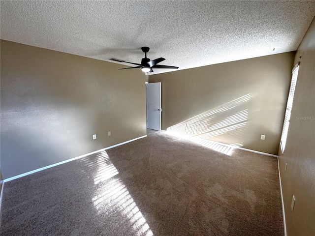 unfurnished room featuring carpet, a textured ceiling, and ceiling fan