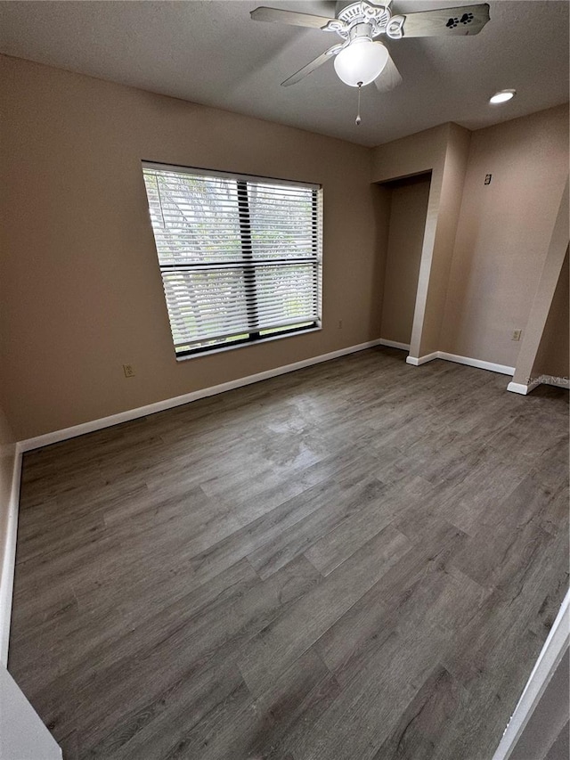 empty room featuring ceiling fan and wood-type flooring