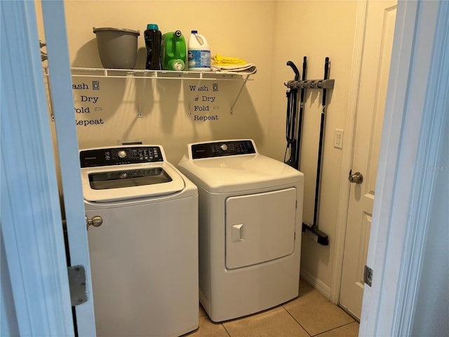 laundry room with light tile patterned floors and washer and dryer