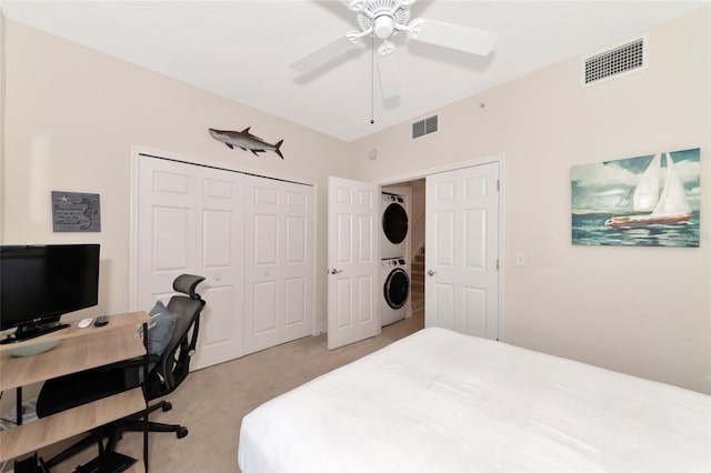 553 Bahia Beach Blvd, Ruskin, FL 33570 - bedroom with stacked washer and clothes dryer, light carpet, ceiling fan, and a closet