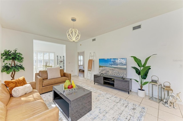 tiled living room with a chandelier