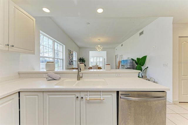 kitchen with dishwasher, white cabinets, sink, and light tile patterned floors