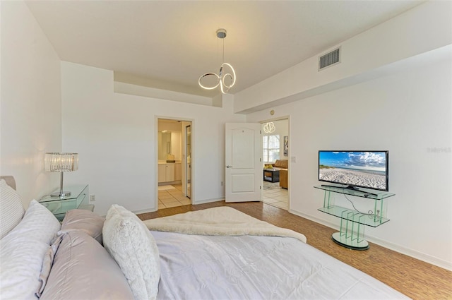 bedroom featuring a notable chandelier and light tile patterned floors