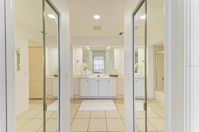 bathroom with vanity, bath / shower combo with glass door, and tile patterned floors