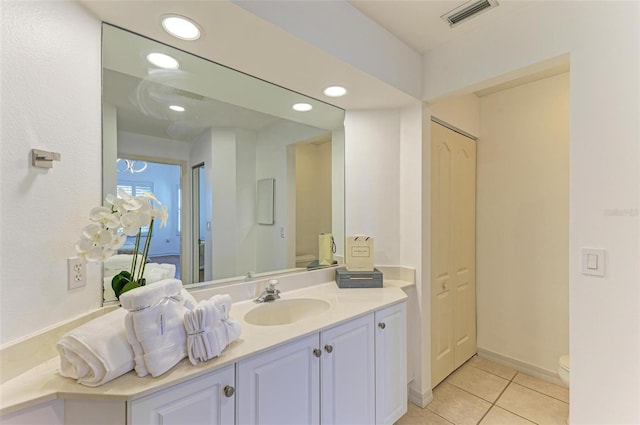 bathroom with vanity, toilet, and tile patterned flooring