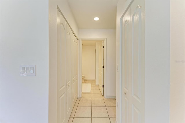 hall with light tile patterned floors