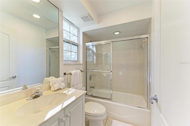 full bathroom with vanity, combined bath / shower with glass door, toilet, and tile patterned floors