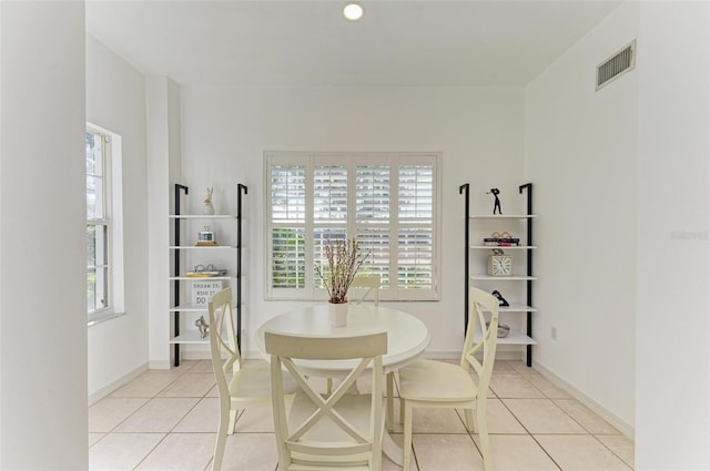 dining space with a wealth of natural light and light tile patterned flooring