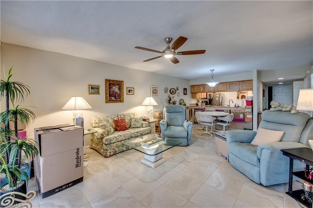 living room featuring ceiling fan and sink