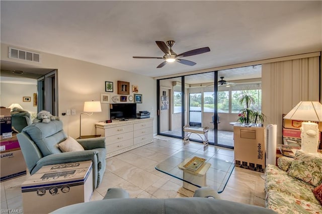 living room with ceiling fan and french doors