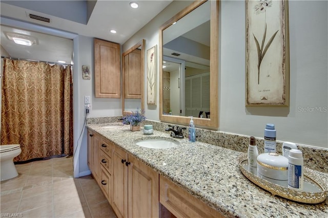 bathroom featuring vanity, toilet, and tile patterned floors