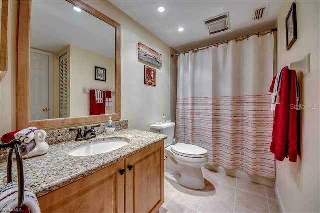 bathroom featuring curtained shower, vanity, toilet, and tile patterned floors