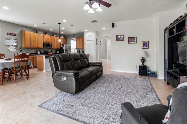 living room with light tile patterned floors and ceiling fan