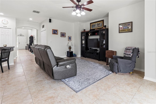 tiled living room with ceiling fan