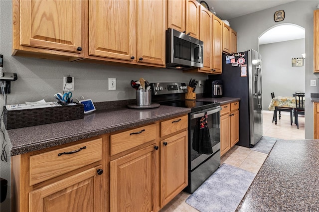 kitchen with appliances with stainless steel finishes and light tile patterned floors