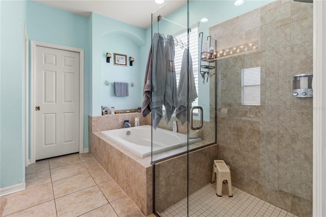 bathroom with separate shower and tub and tile patterned floors