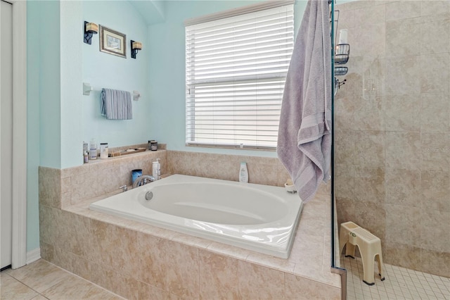 bathroom featuring plus walk in shower and tile patterned floors