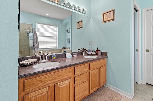 bathroom featuring vanity, a shower, and tile patterned floors