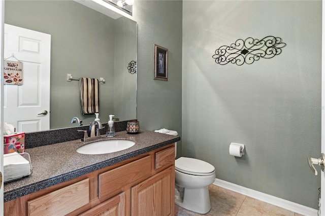 bathroom featuring tile patterned flooring, vanity, and toilet