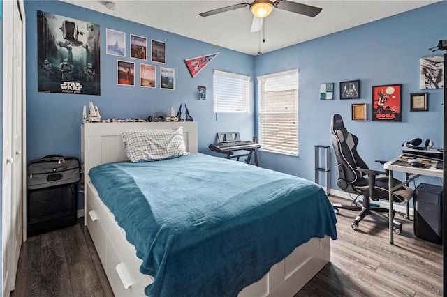 bedroom with ceiling fan and hardwood / wood-style flooring