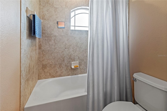 bathroom with shower / bath combo and toilet