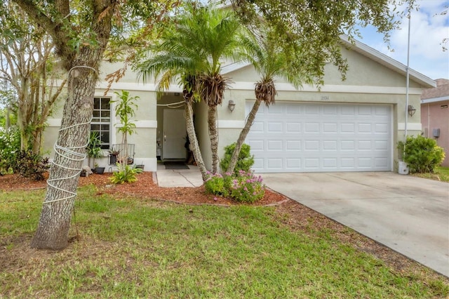 view of front of property featuring a garage and a front lawn