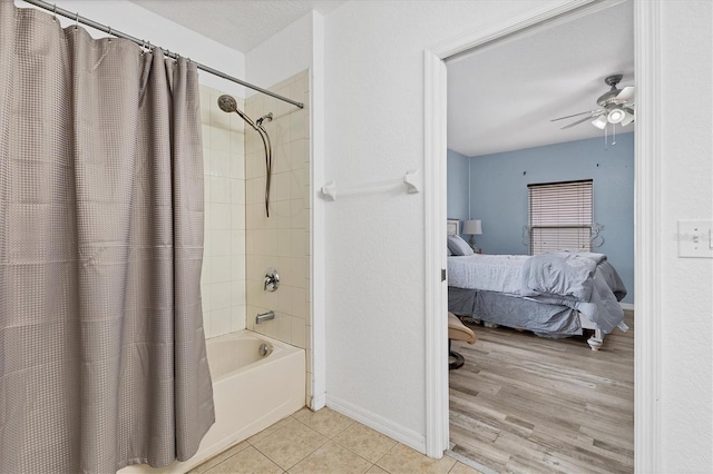 bathroom featuring ceiling fan, wood-type flooring, and shower / bath combo