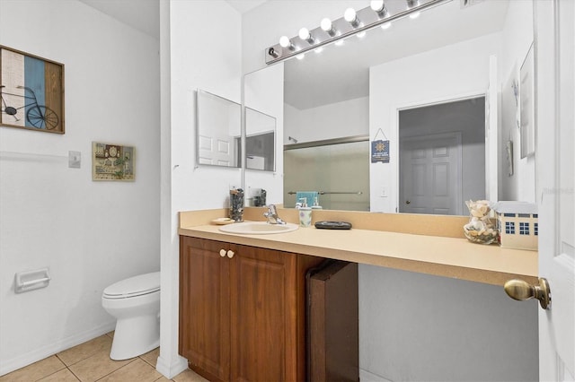 bathroom with tile patterned floors, vanity, and toilet