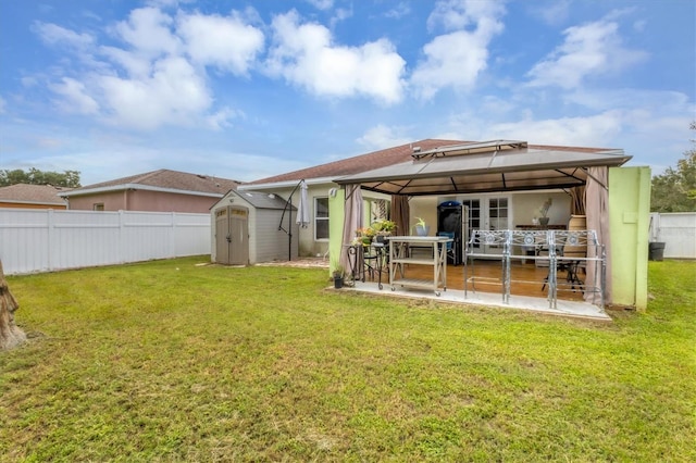 exterior space featuring a shed, a gazebo, and a patio area