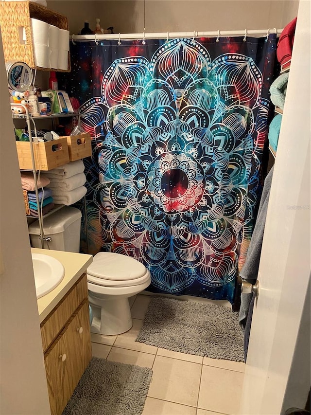 full bathroom featuring vanity, tile patterned flooring, and toilet