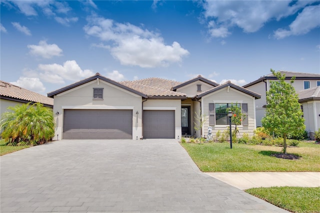 view of front of home with a front yard and a garage