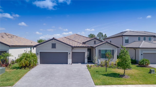 view of front of house with a garage and a front lawn